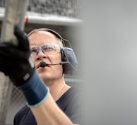 a man wearing a headset and holding a baseball bat