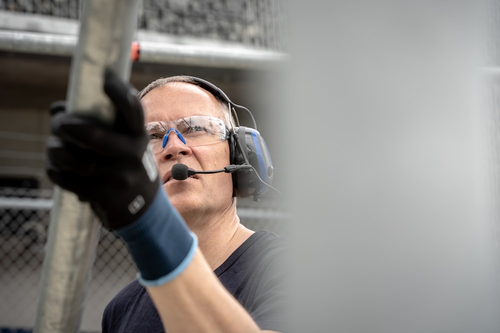 a man wearing a headset and holding a baseball bat