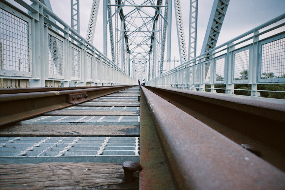 a train track going across a bridge over water