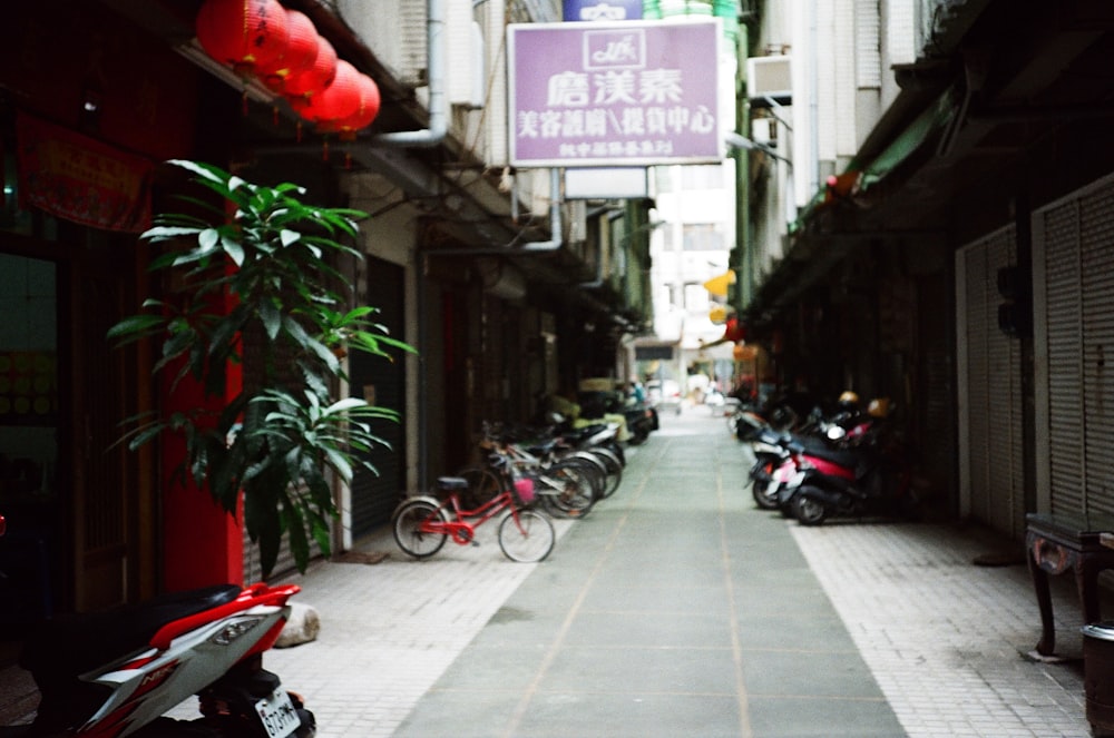 a narrow street with bikes parked on both sides