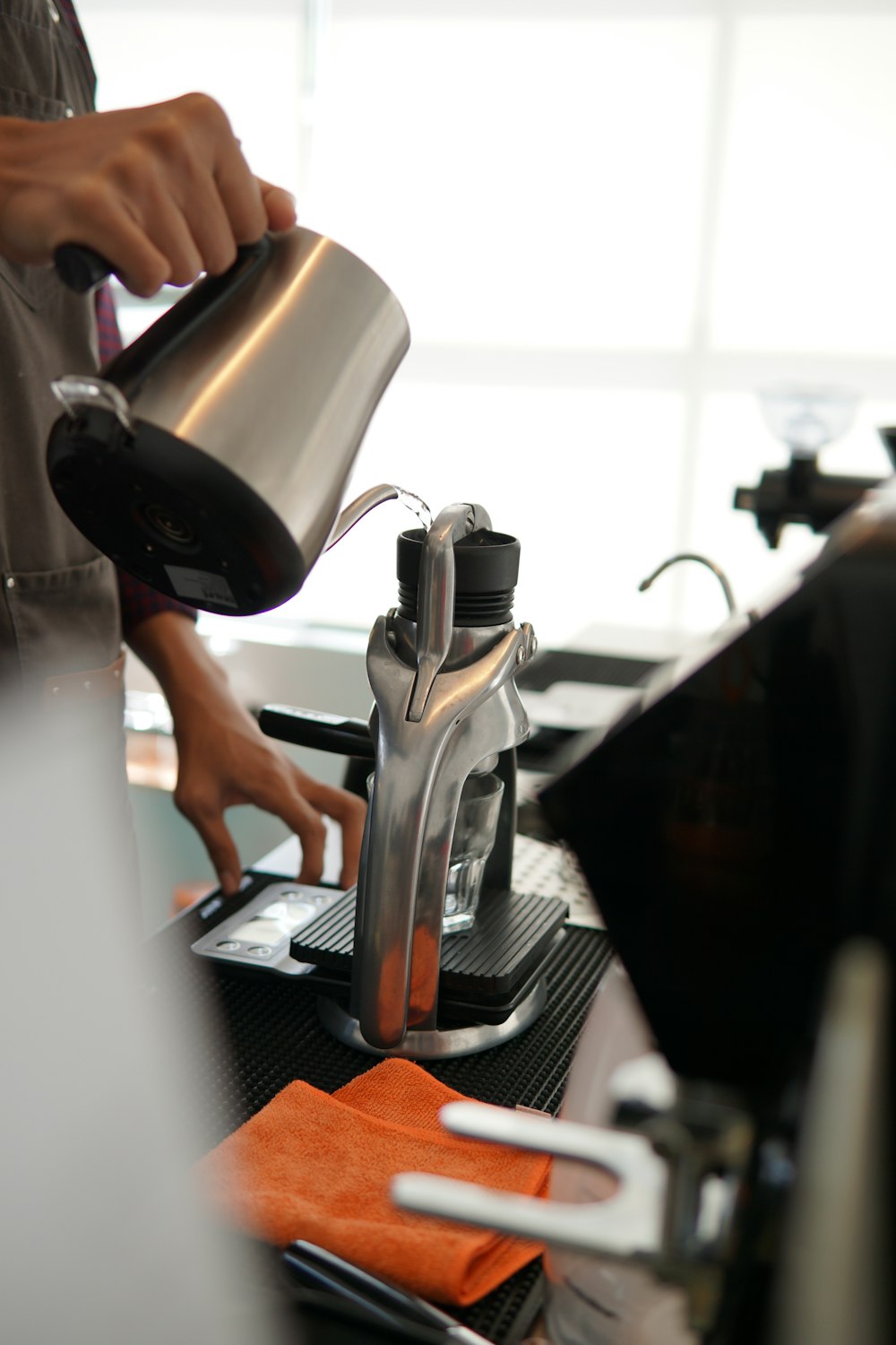 a person pours a cup of coffee from a coffee maker
