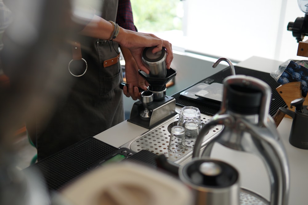 a person pouring a cup of coffee from a coffee maker