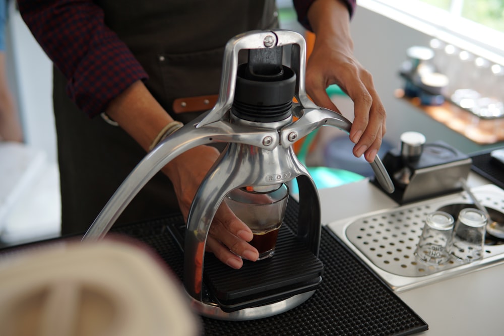 a person pouring coffee into a coffee maker