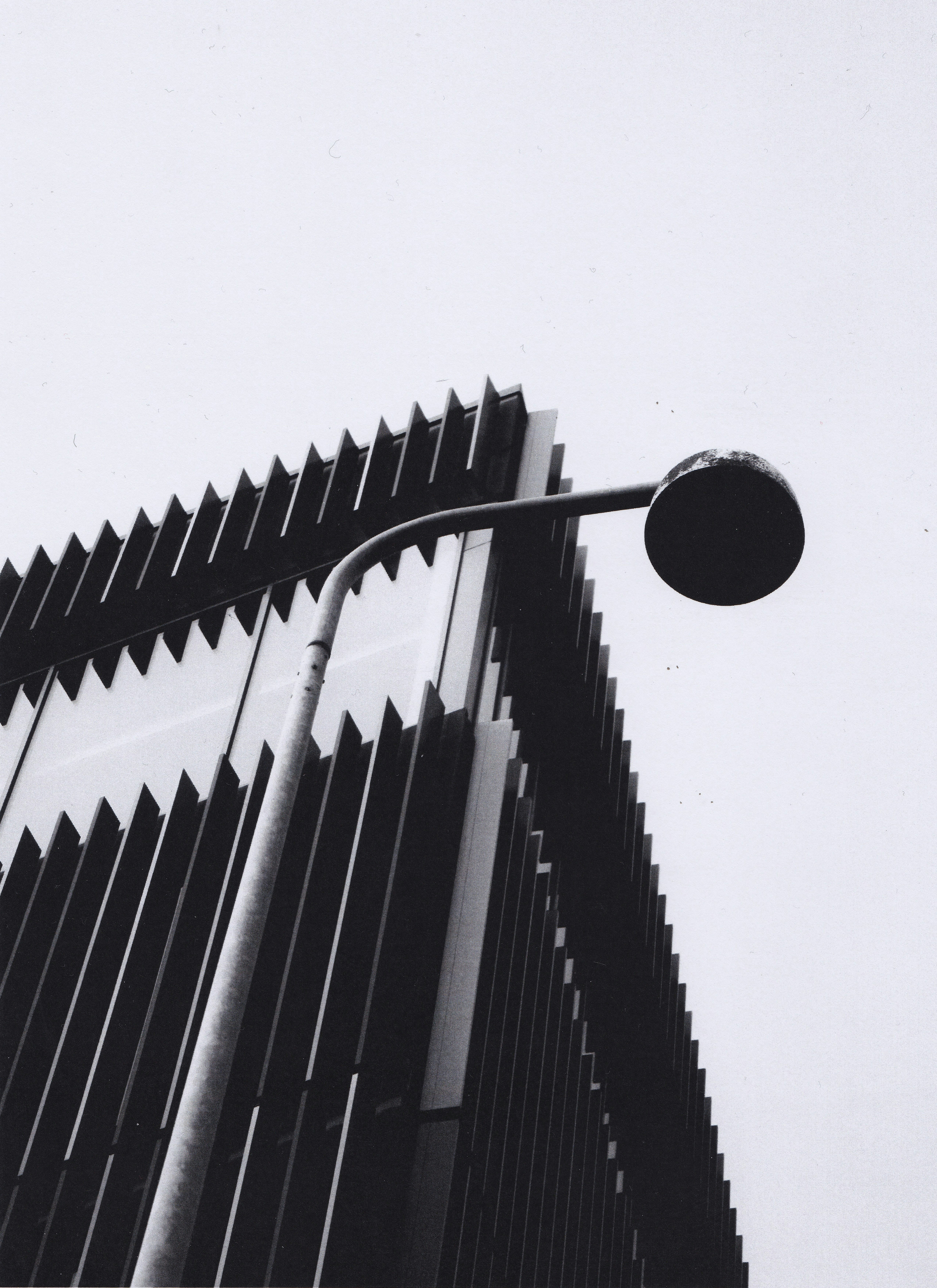 a black and white photo of a street light