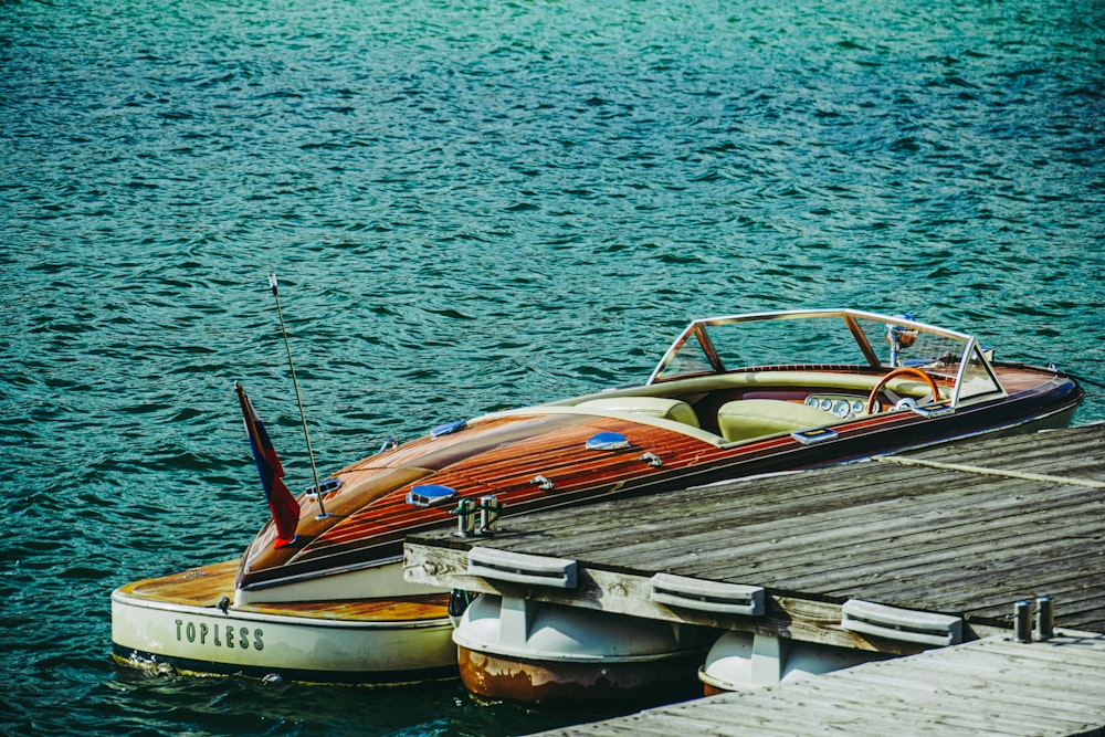 a boat is docked at a pier on the water