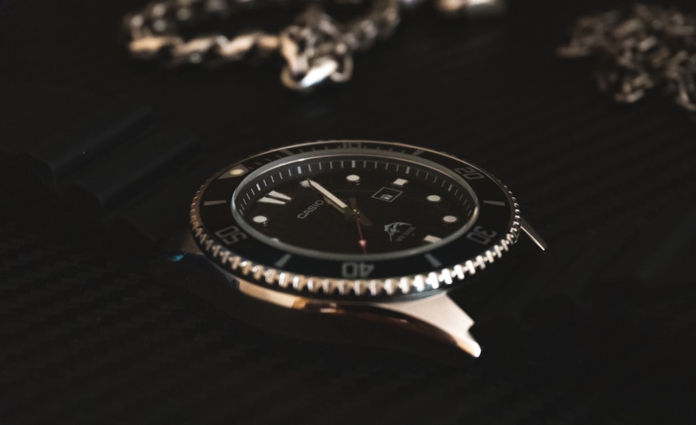 a watch sitting on top of a black table