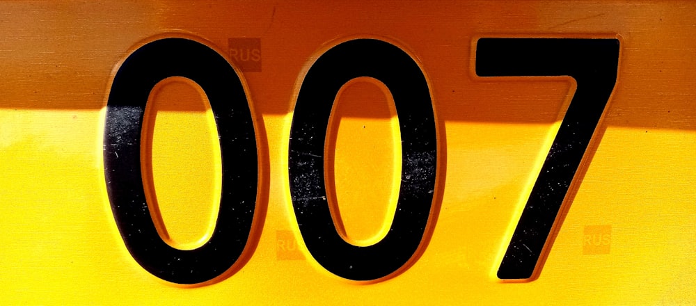 a close up of the number seventy on a yellow sign