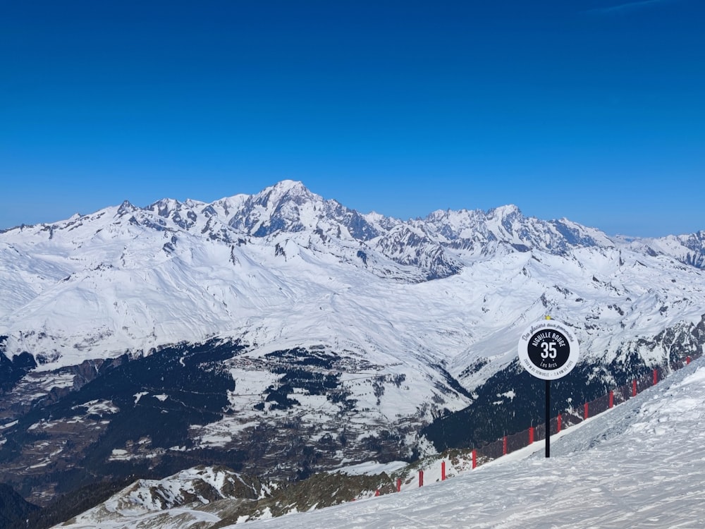 a snow covered mountain with a clock on it