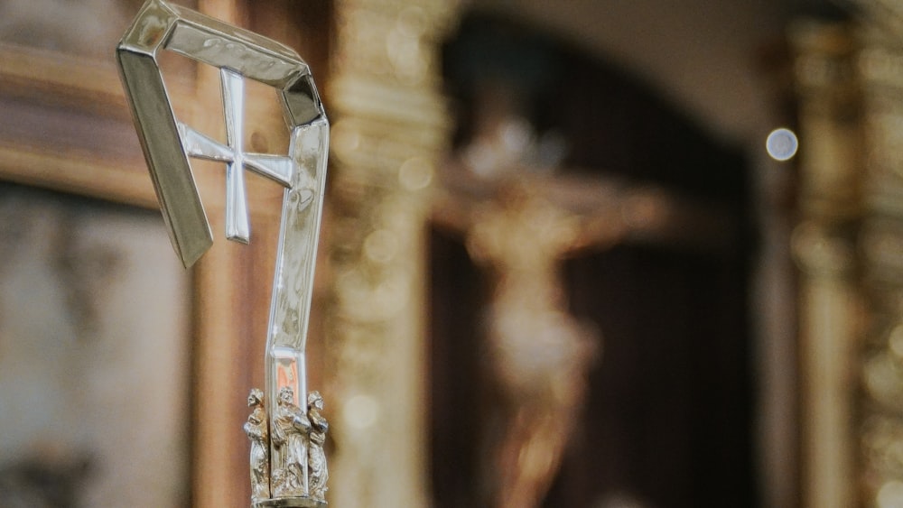 a cross hanging from the side of a wall