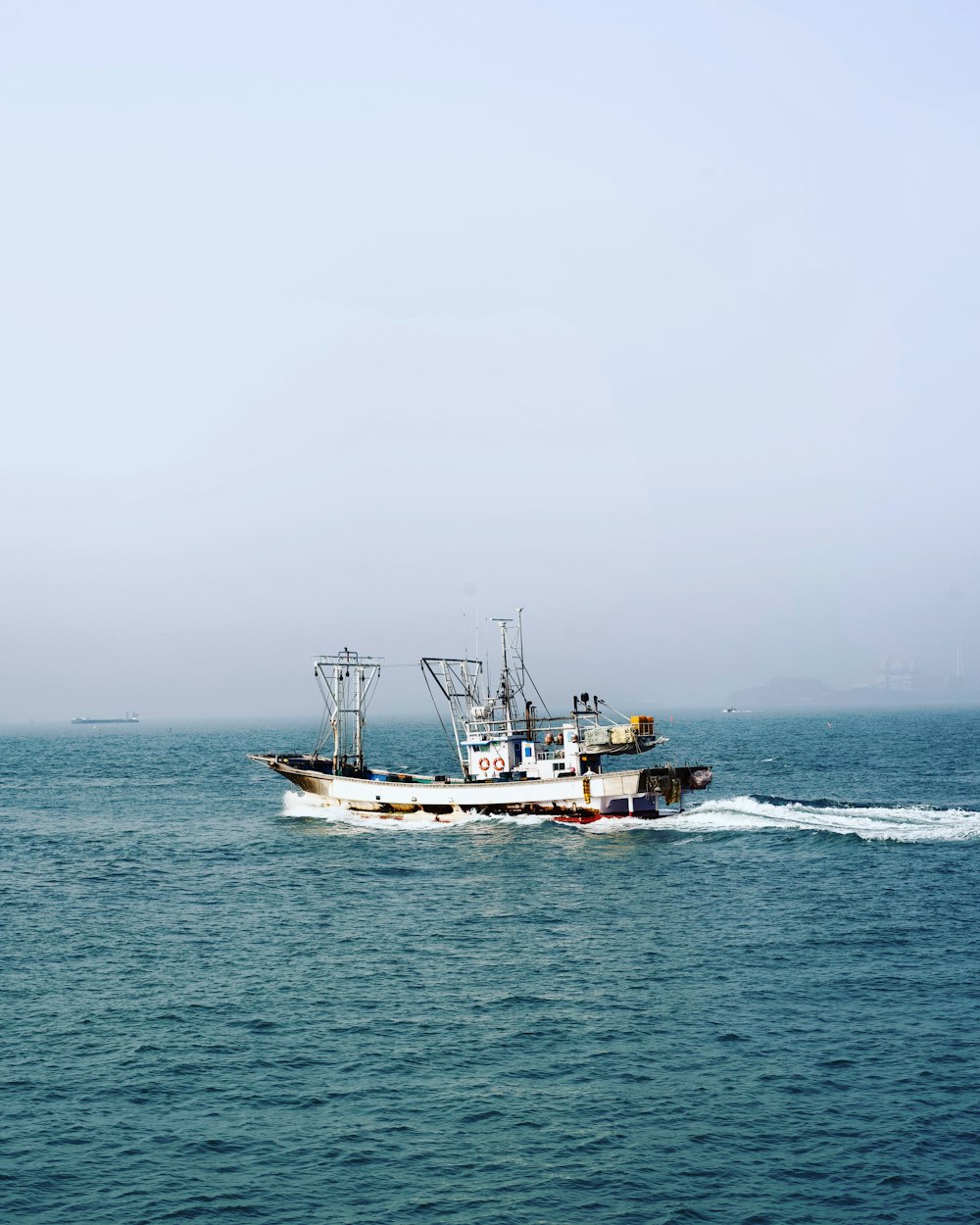 a fishing boat in the middle of the ocean