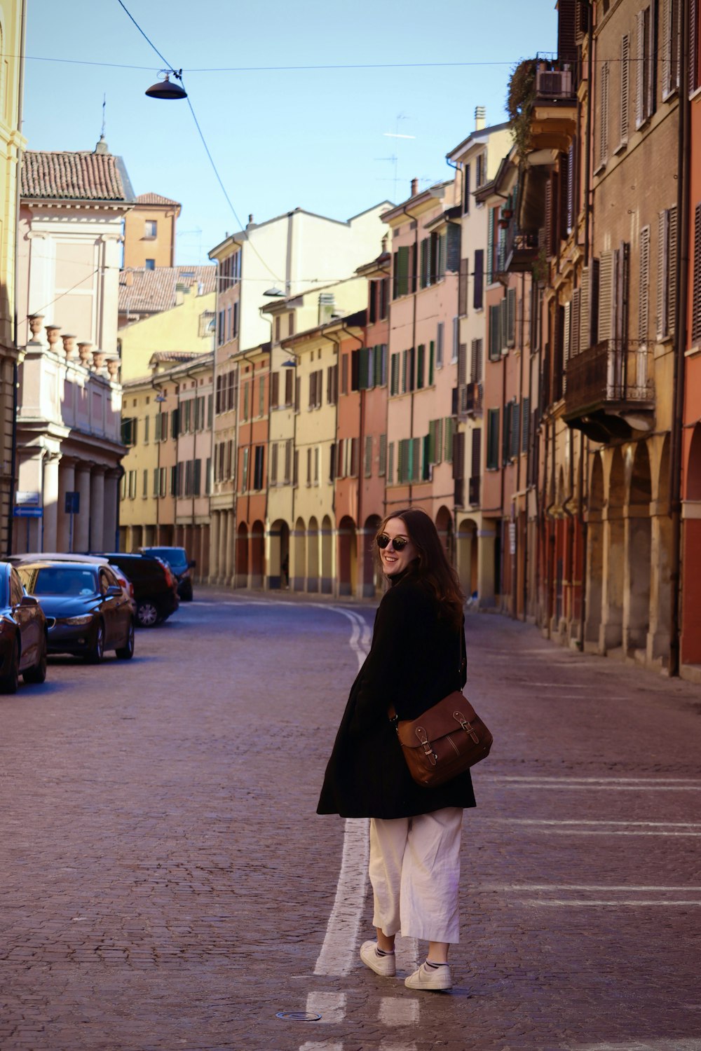 a woman standing in the middle of a street