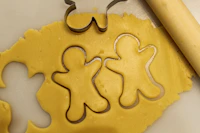 Holiday-themed cookie cutters arranged on a baking sheet
