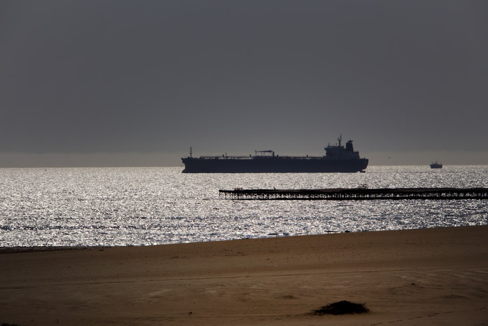 a large cargo ship in the middle of the ocean