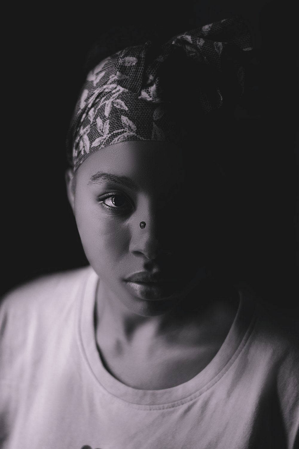 a woman with a bandana on her head