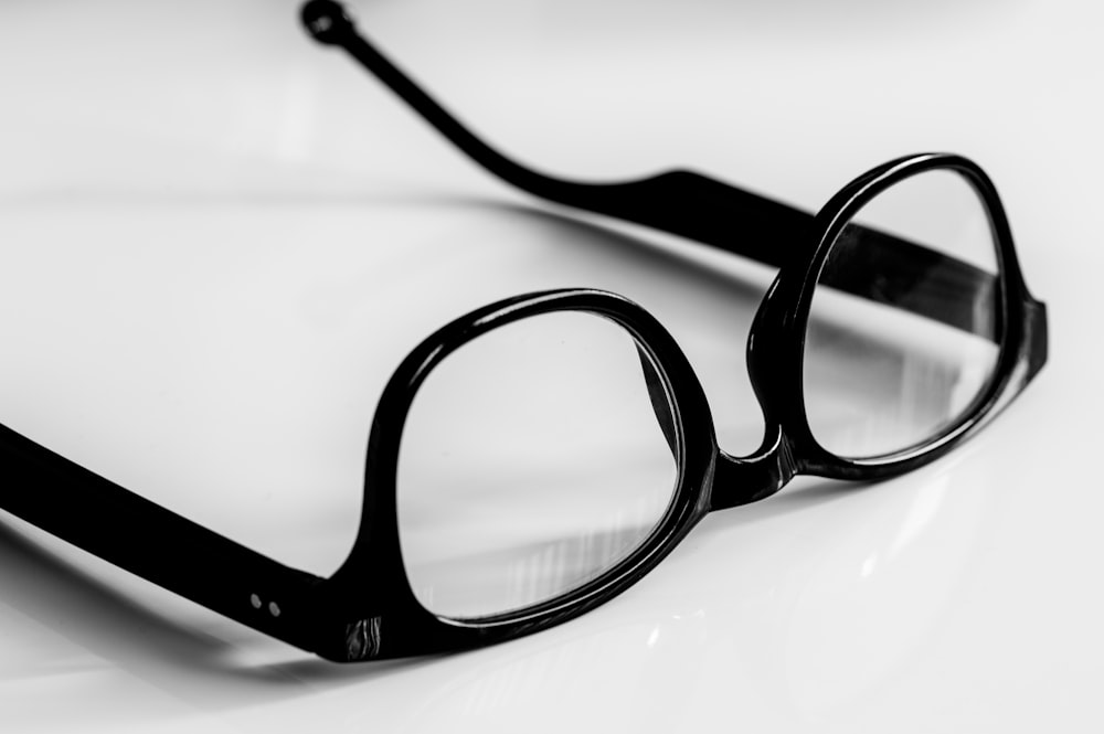a pair of glasses sitting on top of a table