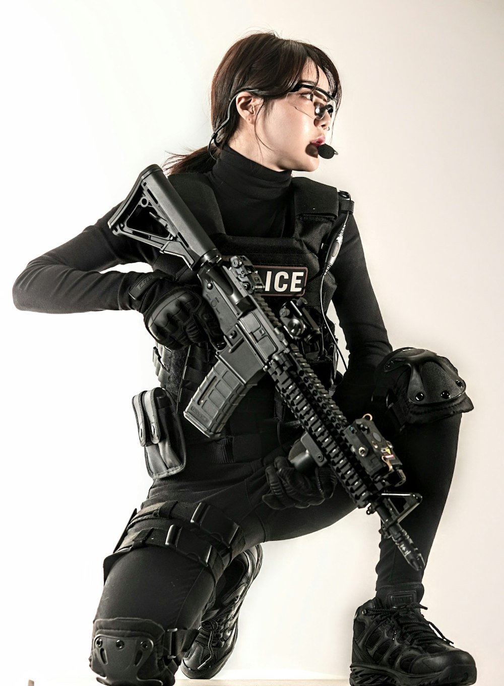 a woman in a police uniform holding a gun