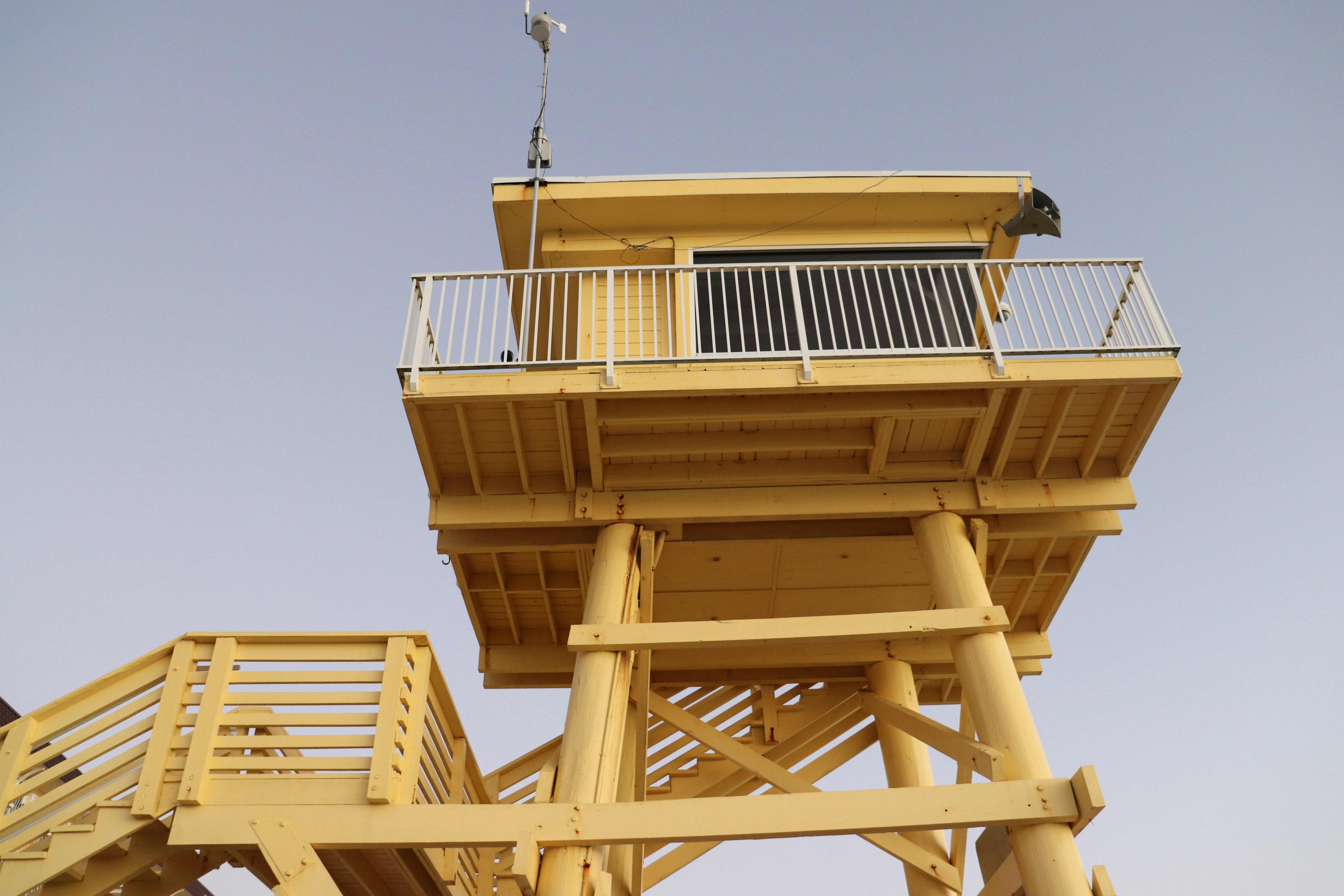 a tall yellow tower with a sky background