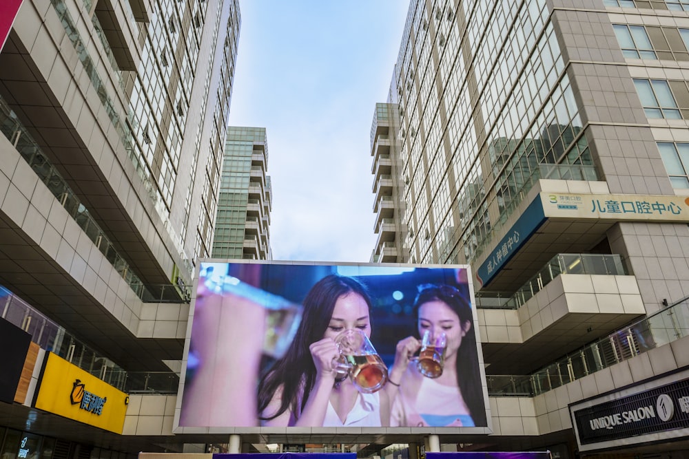 a large billboard with a picture of two women drinking beverages