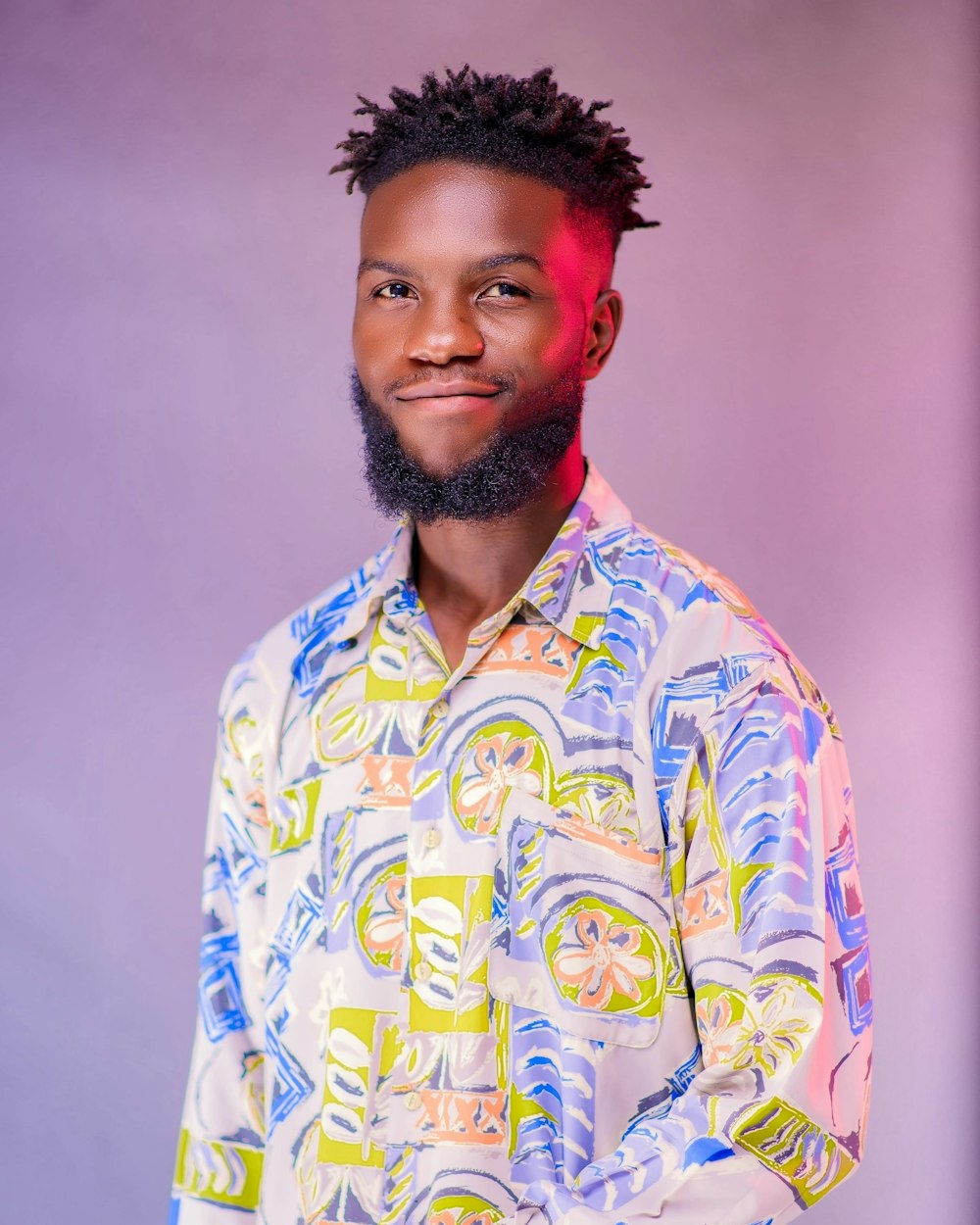 a man with a beard wearing a colorful shirt