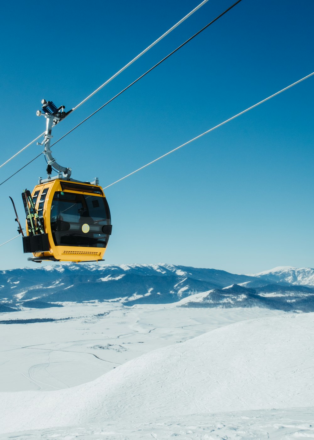 a ski lift with a skier on it in the snow