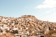 a very large city with a very tall hill in the background