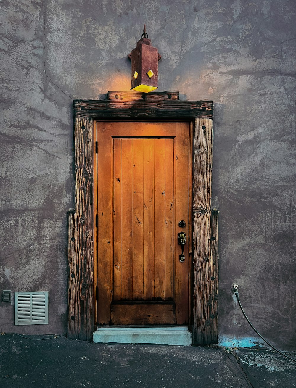 a wooden door with a light on top of it