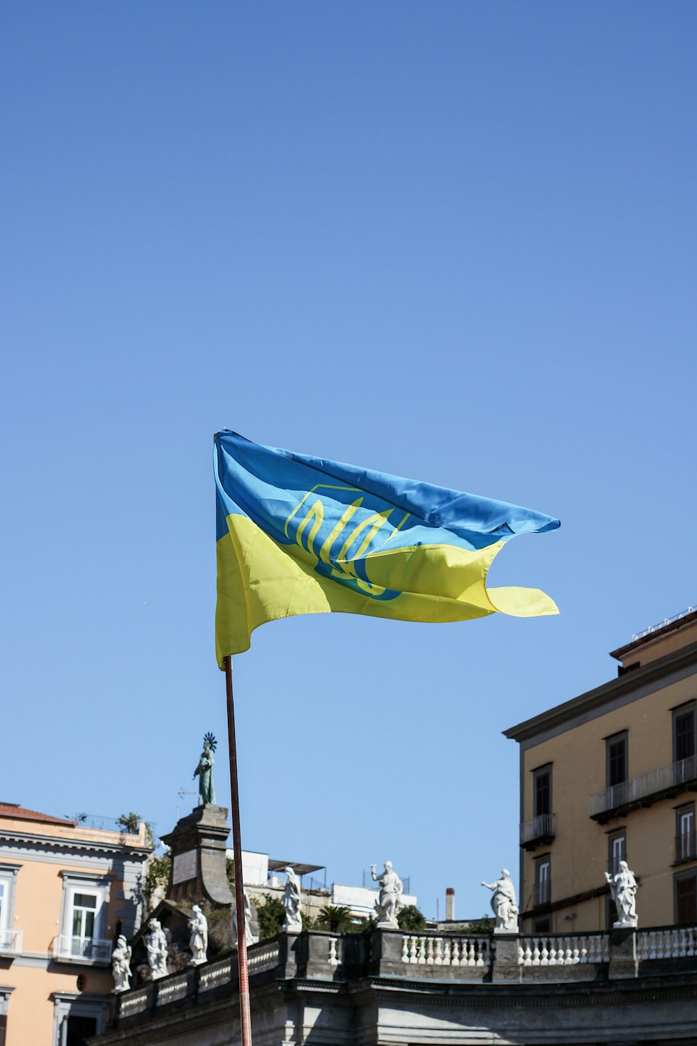 a blue and yellow flag flying in the wind