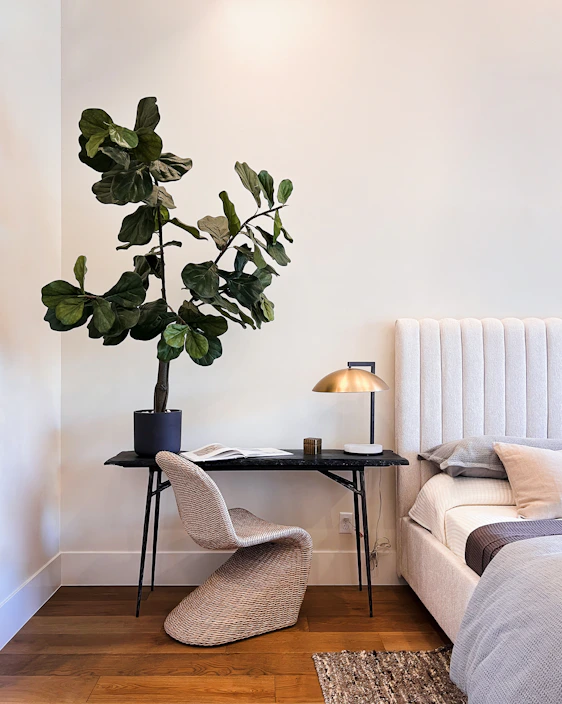 Cozy bedroom corner featuring warm lighting, olive green accents, and elegant decor
