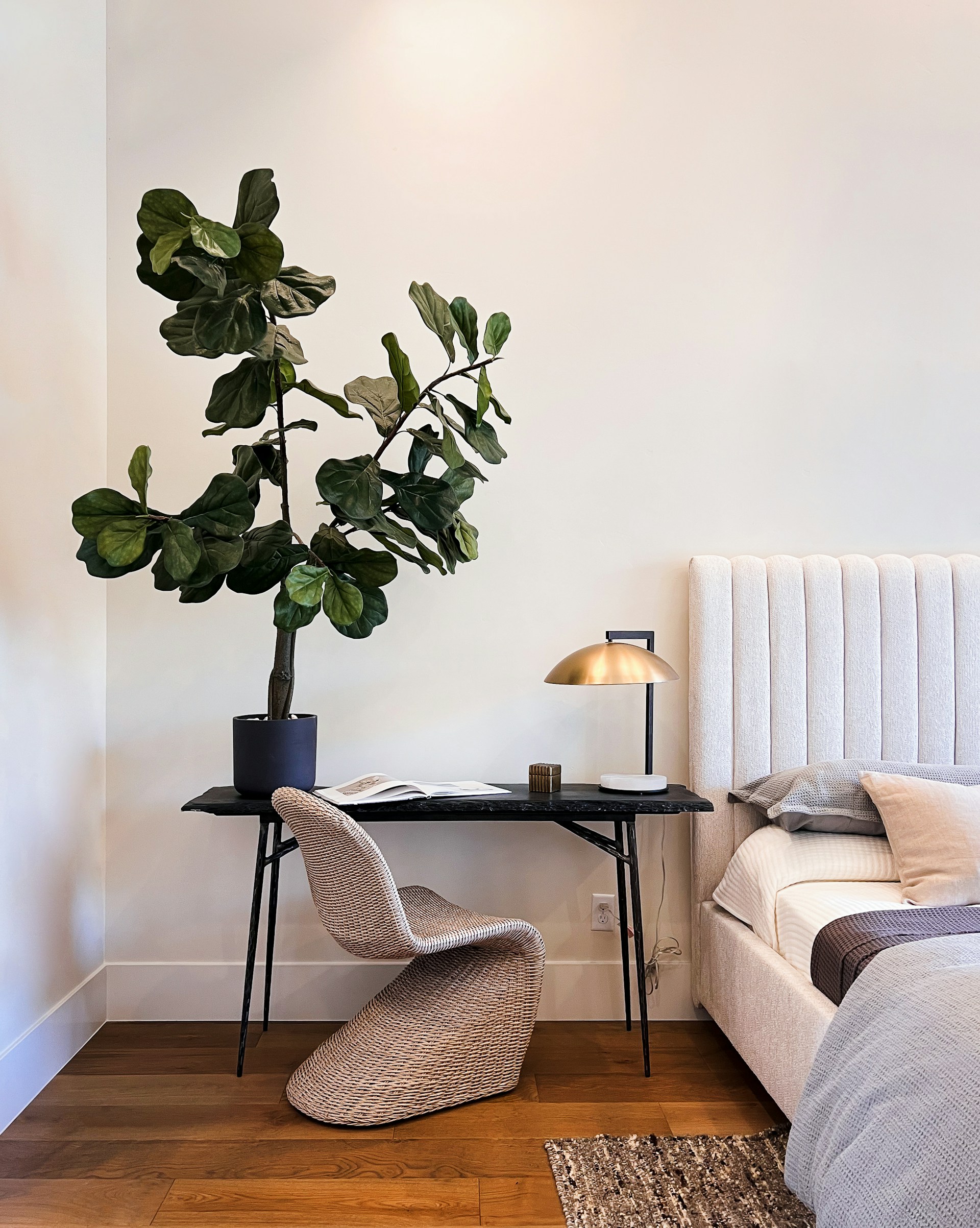 A stylish bedroom corner outfitted with Weaboard’s high-quality furniture, including a minimalist dresser and a comfy reading chair.