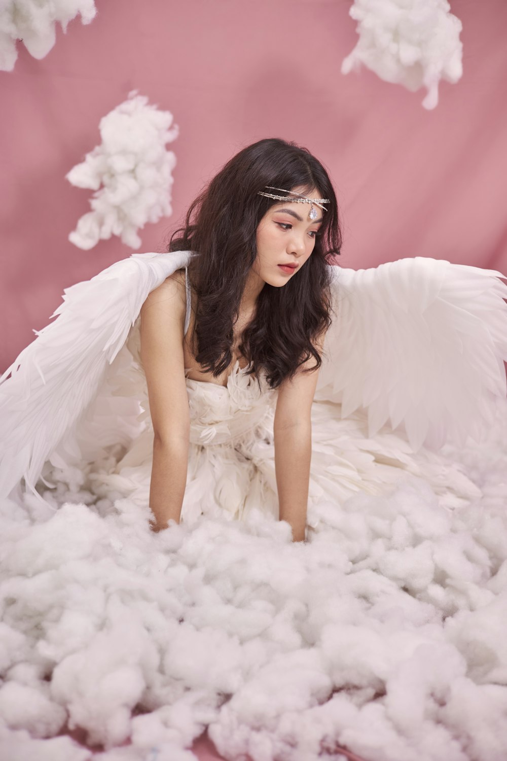 a woman in a white dress surrounded by cotton