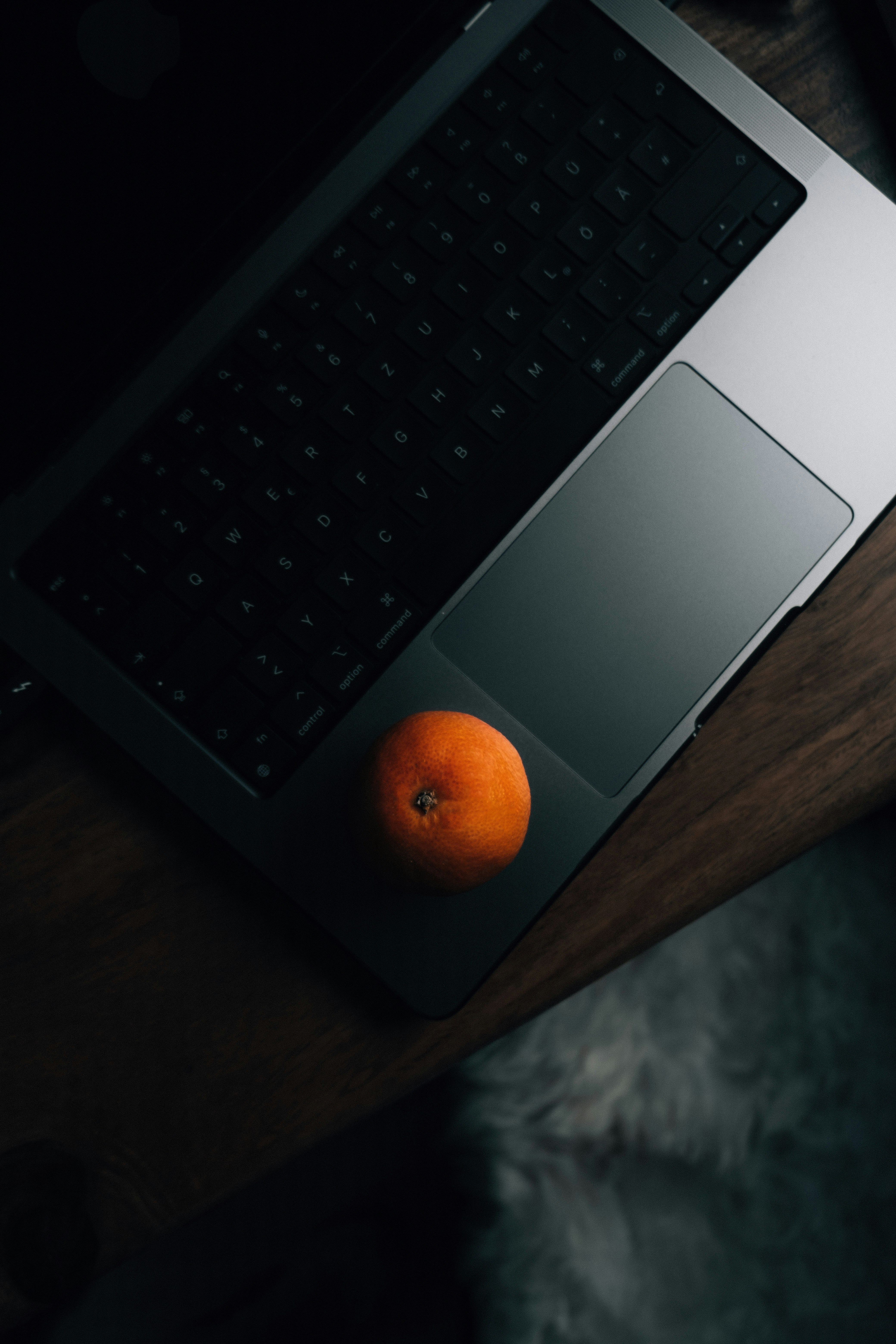 a laptop computer sitting on top of a wooden desk