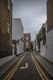 a narrow street with a yellow line painted on it