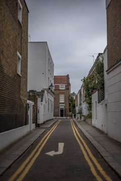 a narrow street with a yellow line painted on it