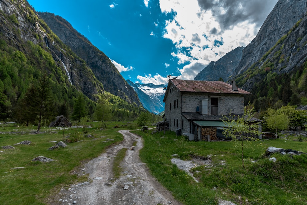 an old house in the middle of a mountain valley