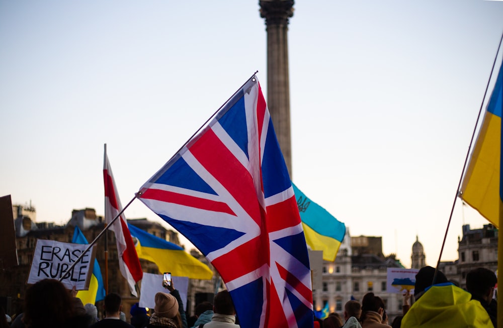 a group of people holding flags and signs