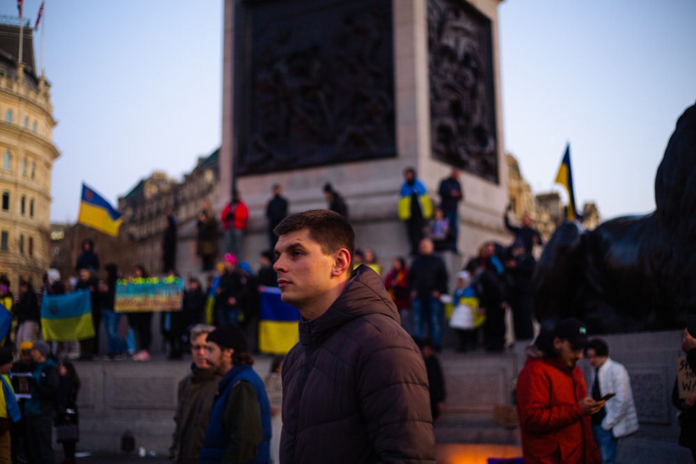 a man is standing in front of a statue