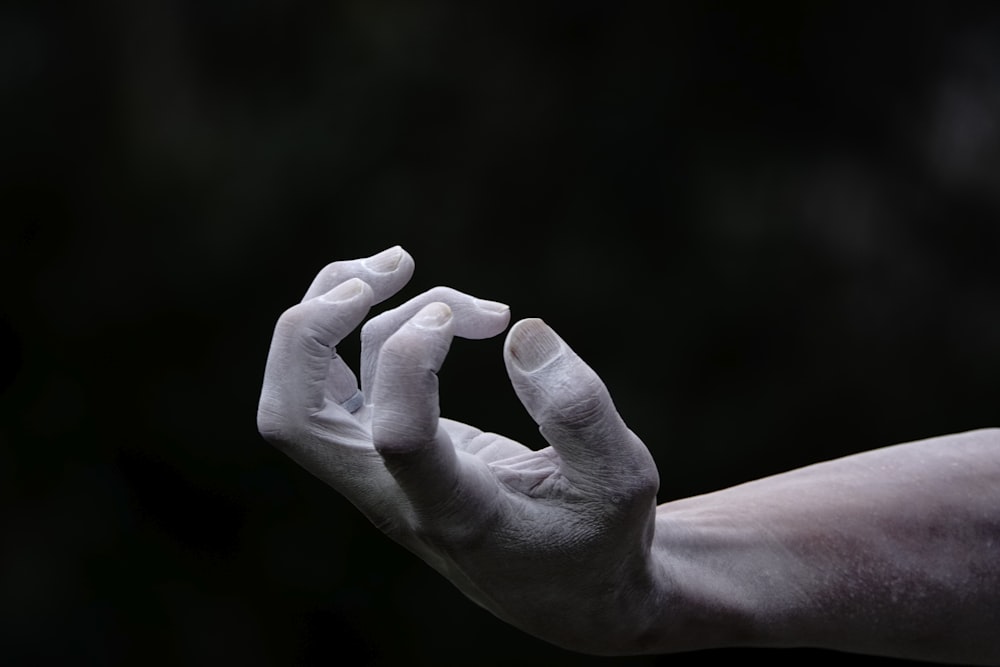 a person's hand with white paint on it