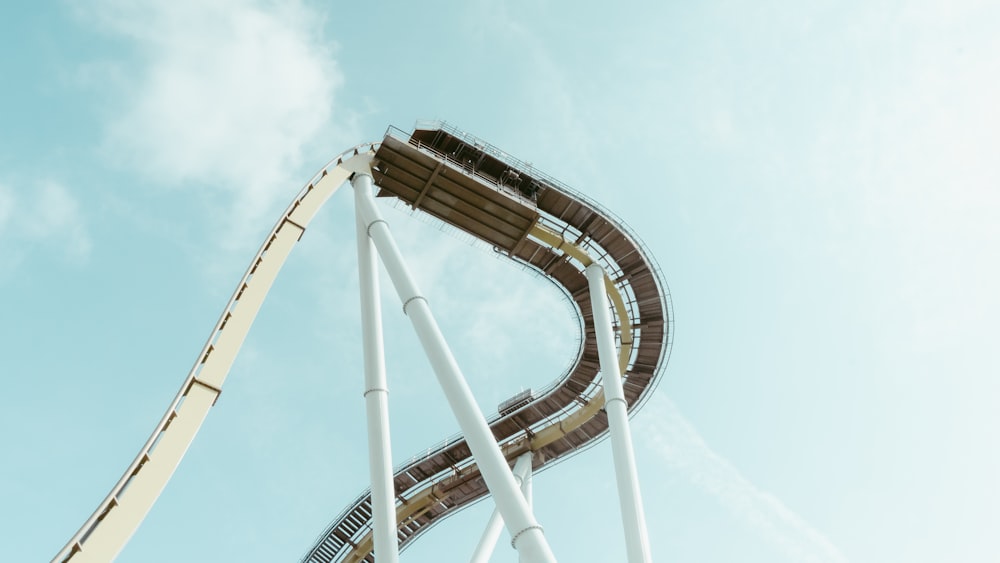 a roller coaster going down a hill on a sunny day