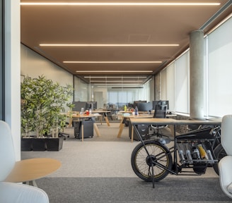 an office with a bike parked in the middle of the room
