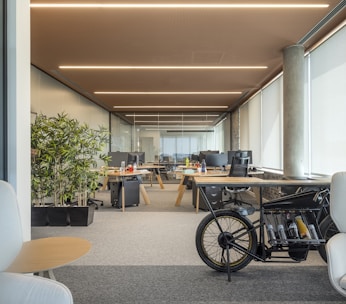 an office with a bike parked in the middle of the room