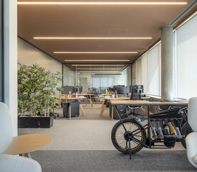 an office with a bike parked in the middle of the room