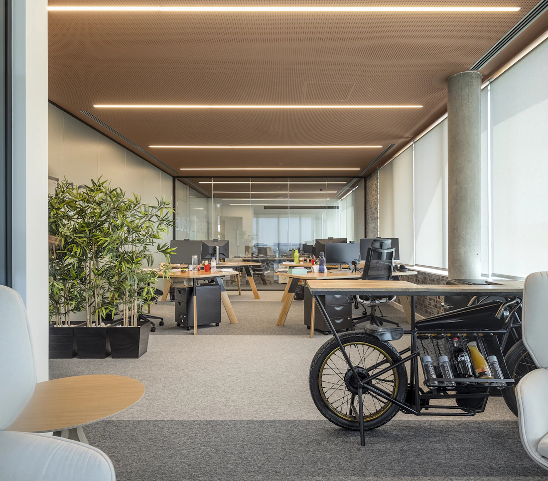 A warm-toned open-plan office workspace