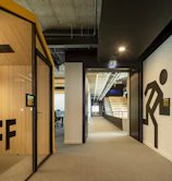 a hallway leading to an office with a sign on the wall