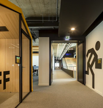 a hallway leading to an office with a sign on the wall