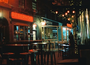 a restaurant at night with people sitting at tables