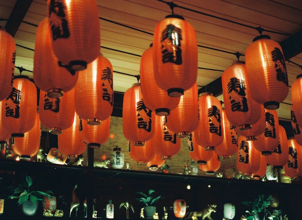 a room filled with lots of orange lanterns