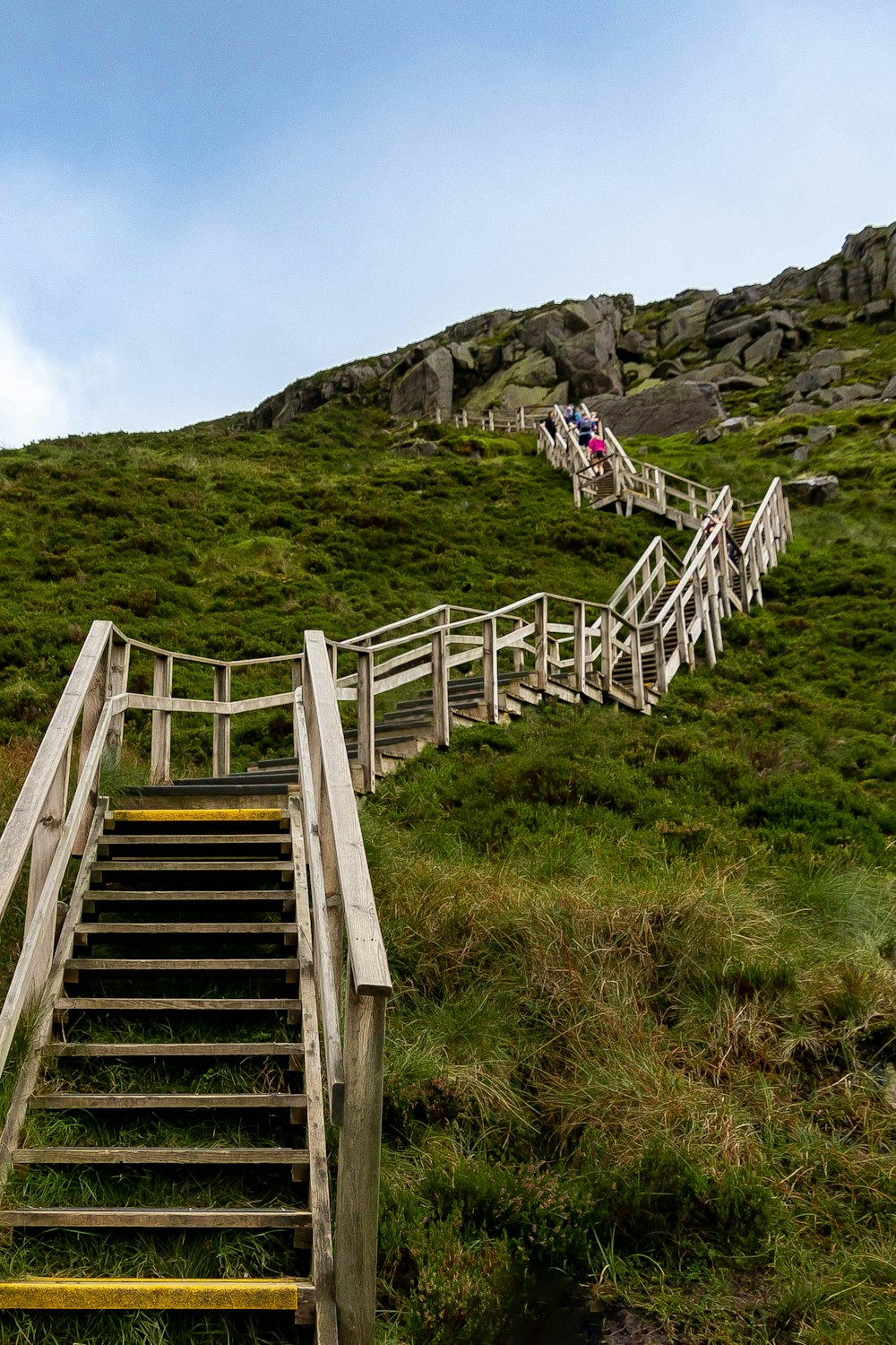 a group of people walking up a wooden staircase