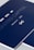 A close-up of a sleek dark blue cover design featuring text in white and light gray, including 'CASTRO CAPITAL .COM', 'SAN LUIS, S.L.P.', and a number '78214'. The design includes a stylized logo with interlocking letters.