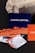 Several business cards are displayed in various colors and patterns. A dark blue card with white text reading 'Castro Capital' is prominently positioned in the background. In the foreground, there are numerous cards with woven red and orange designs, along with others featuring architectural imagery. Behind the blue card, a textured rock provides a contrasting natural element against the smooth cards.