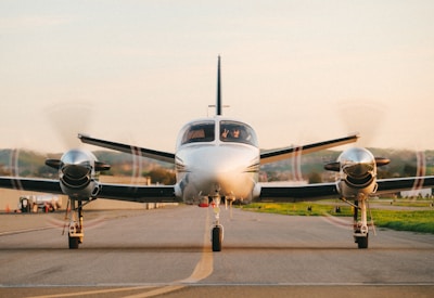 a small propeller plane sitting on top of an airport runway